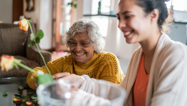 Elderly woman and young girl smiling
